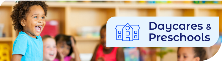 Happy child laughing in a bright classroom next to a Daycares & Preschools banner, highlighting safe janitorial services and commercial cleaning standards for educational facilities.